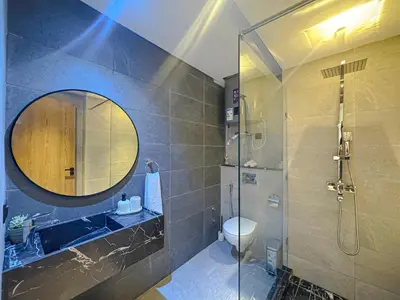 a bathroom with a shower and a sink and a mirror at Luxury Studio Guéliz Pools, Jacuzzi Fitness in Marrakech