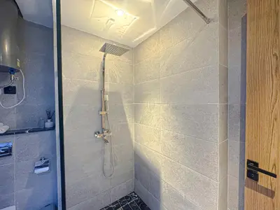 a bathroom with a shower with a glass door at Luxury Studio Guéliz Pools, Jacuzzi Fitness in Marrakech