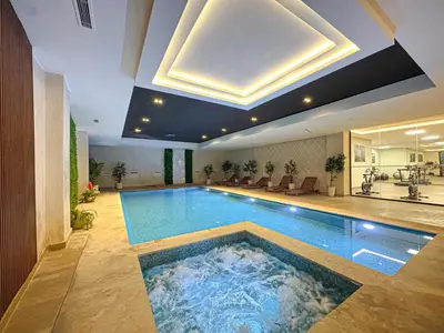 a large swimming pool in a large room with at Luxury Studio Guéliz Pools, Jacuzzi Fitness in Marrakech