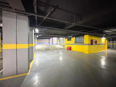 an empty parking garage with a yellow and blue wall at Luxury Studio Guéliz Pools, Jacuzzi Fitness in Marrakech