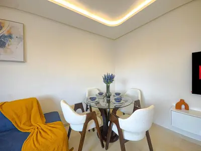 a dining room with a table and white chairs at Luxury Studio Guéliz Pools, Jacuzzi Fitness in Marrakech