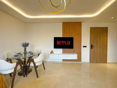 a dining room with a tv and a table and chairs at Luxury Studio Guéliz Pools, Jacuzzi Fitness in Marrakech