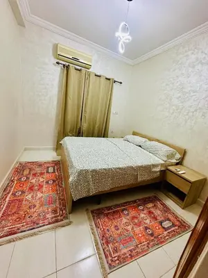 a bedroom with two beds and two rugs at Soman Marrakech in Marrakech