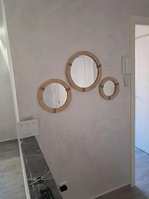 three circular mirrors on a wall with a counter at comfortable stay in Marrakesh in Marrakech