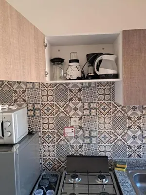 a kitchen with a stove and tiles on the wall at comfortable stay in Marrakesh in Marrakech