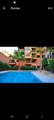 a picture of a swimming pool in front of a building at L'hivernage andalouse in Marrakech