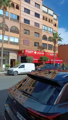 a black car parked in front of a building at L'hivernage andalouse in Marrakech