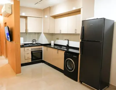 a kitchen with a black refrigerator and a dishwasher at The Skybox your private seat at the city s show in Marrakech