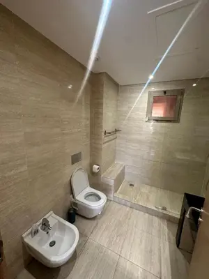 a bathroom with a toilet and a sink at Marrakech village -2 chambres jardin avec jacuzzi in Marrakech