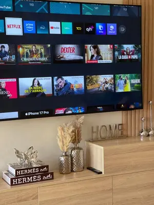 a tv sitting on top of a shelf with a tv screen at Appartement luxe avec piscine in Marrakech
