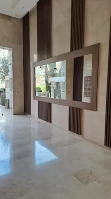 a large empty room with a large mirror on the wall at Appartement luxe avec piscine in Marrakech