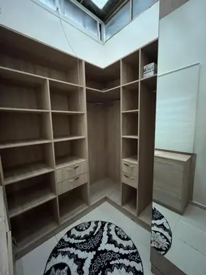 a room with wooden shelves and a window and a rug at Garden Apartment 5 min from Gueliz in Marrakech