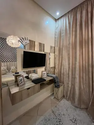 a living room with a large television and a couch at Garden Apartment 5 min from Gueliz in Marrakech