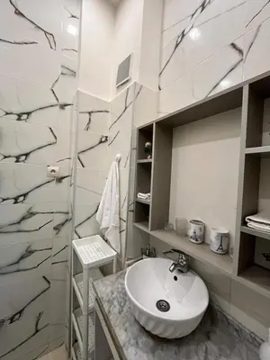a white bathroom with a sink and a counter at Garden Apartment 5 min from Gueliz in Marrakech