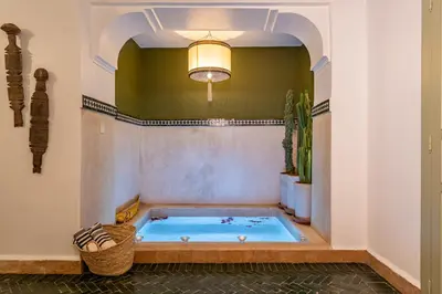 a large indoor hot tub in a room with a ceiling at Riad JewelBox Exclusive Stay In the Medina in Marrakech
