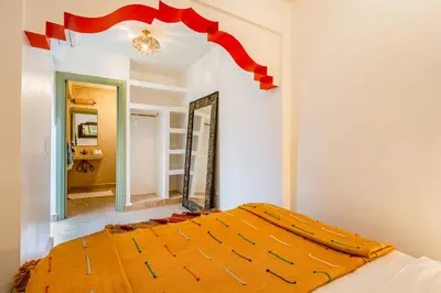 a bedroom with a bed with a large mirror at Riad JewelBox Exclusive Stay In the Medina in Marrakech