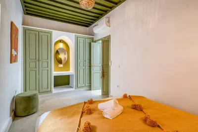 a bedroom with a large bed in a room at Riad JewelBox Exclusive Stay In the Medina in Marrakech