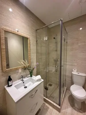 a bathroom with a shower and a sink and a toilet at Prestigia Jade Beautiful Apartment Marrakesh in Marrakech