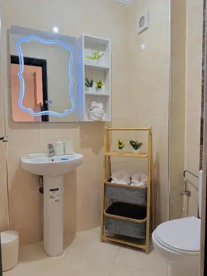 a bathroom with a sink and a mirror and a toilet at Marrakech Cosy appartement 2 chambres - Confort in Marrakech