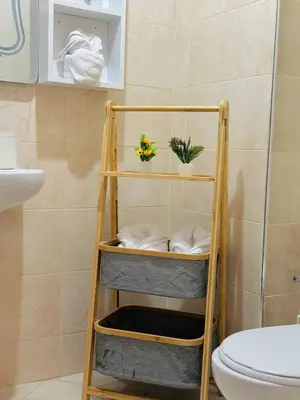 a wooden towel rack in a bathroom with a toilet at Marrakech Cosy appartement 2 chambres - Confort in Marrakech