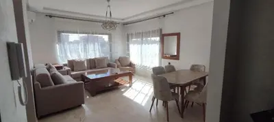 a living room with a table and a dining room at Light filled Urban Retreat in Marrakech