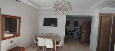 a dining room with a table and chairs and a mirror at Light filled Urban Retreat in Marrakech