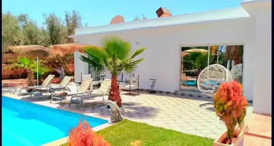a villa with a swimming pool and a resort at Villa Riad Dar Sukar in Marrakech