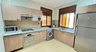 a kitchen with a refrigerator and a dishwasher at boulevard oued issil Palmeraie in Marrakech