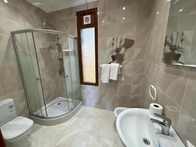 a bathroom with a sink and a shower and a toilet at boulevard oued issil Palmeraie in Marrakech