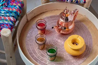 a tray with a tea pot and two glasses on a chair at Mabrouka apartment 10 minutes from Guéliz in Marrakech