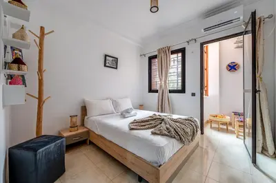 a bedroom with a large bed and a window at Mabrouka apartment 10 minutes from Guéliz in Marrakech
