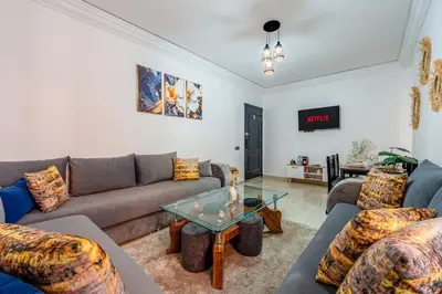 a living room with couches and a glass table at Mabrouka apartment 10 minutes from Guéliz in Marrakech