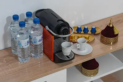 a toaster sitting on a table with water bottles at Mabrouka apartment 10 minutes from Guéliz in Marrakech
