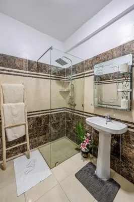 a bathroom with a glass shower and a sink at Mabrouka apartment 10 minutes from Guéliz in Marrakech