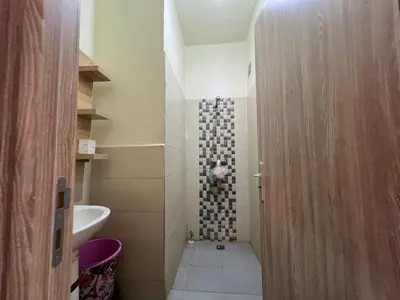 a small bathroom with a shower and a toilet at Cozy & Modern Apartment Minutes from Menara Airport in Marrakech