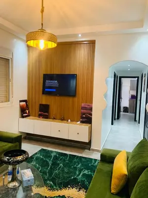 a living room with a couch and a tv at appartement lumineux parfait Cosy prêt de Guéliz in Marrakech
