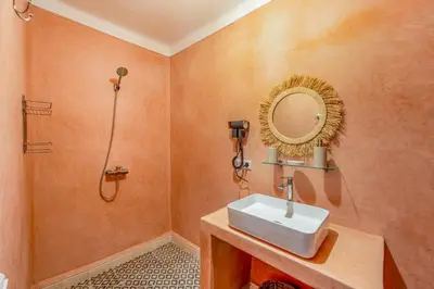 a bathroom with a sink and a shower and a mirror at Riad Cherifa Breakfast and Jacuzzi Terrace in Marrakech