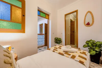 a bedroom with a bed with towels on it at Riad Cherifa Breakfast and Jacuzzi Terrace in Marrakech