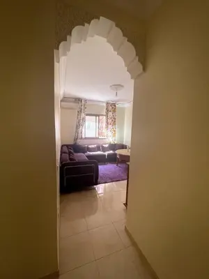 a living room with a couch and a table at Le petit Marrakchi in Marrakech