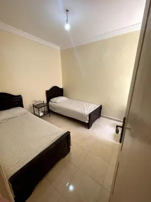 a bedroom with two beds in a room with at Le petit Marrakchi in Marrakech