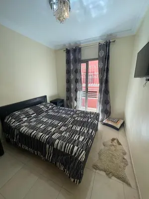 a bedroom with a bed and a window at Le petit Marrakchi in Marrakech