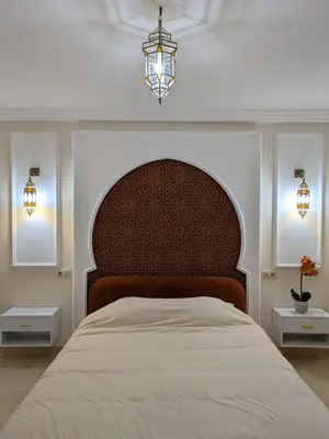 a bedroom with a large bed and two windows at Majorelle Terracotta Spa in Marrakech