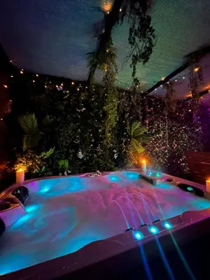 a night view of a swimming pool with lights at Majorelle Terracotta Spa in Marrakech