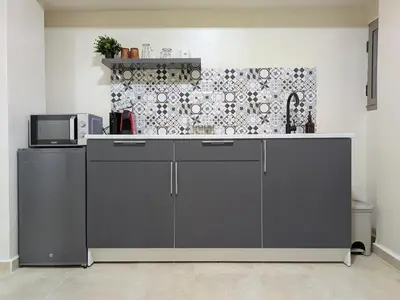 a kitchen with a counter top with a microwave at Majorelle Terracotta Spa in Marrakech