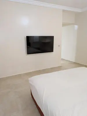a bedroom with a bed and a television on a wall at Majorelle Terracotta Spa in Marrakech