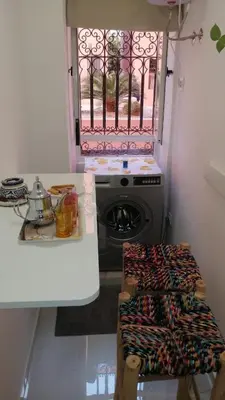 a kitchen with a washing machine and a window at Marrakech Gueliz Apartement in Marrakech