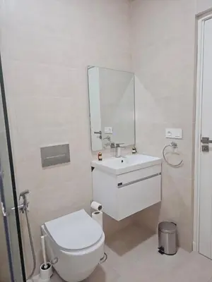a bathroom with a toilet and a sink and a mirror at Marrakech Gueliz Apartement in Marrakech