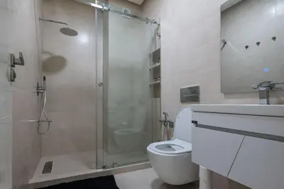 a bathroom with a shower and a toilet and a sink at Marrakech Gueliz Apartement in Marrakech