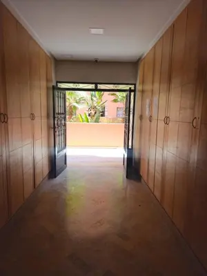 an empty hallway with a door open to a building at Marrakech Gueliz Apartement in Marrakech