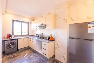 a kitchen with a refrigerator and a dishwasher at Marrakesh 2 BR Apartment in Marrakech